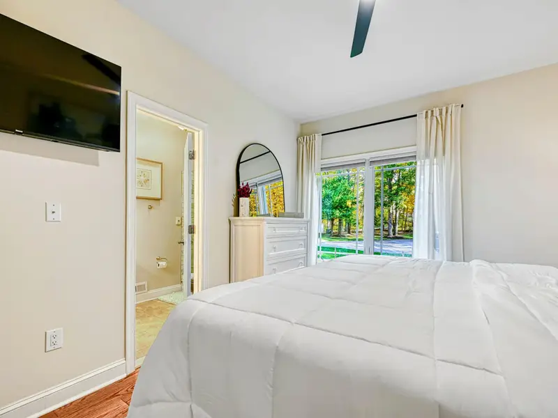 The Junior Primary Suite offers main-level privacy with a cloud-comfortable bed, soft natural light, private ensuite bath, blackout drapery, and spacious storage—perfect for guests who value quiet, comfort, and an elevated suite experience.