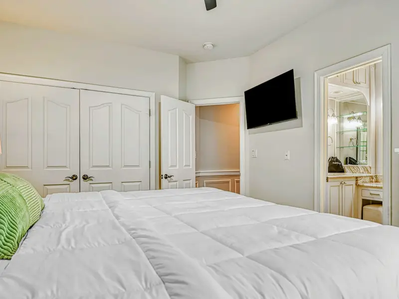 The Junior Primary Suite offers main-level privacy with a cloud-comfortable bed, soft natural light, private ensuite bath, blackout drapery, and spacious storage—perfect for guests who value quiet, comfort, and an elevated suite experience.