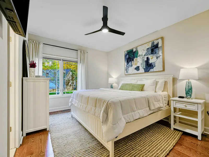 The Junior Primary Suite offers main-level privacy with a cloud-comfortable bed, soft natural light, private ensuite bath, blackout drapery, and spacious storage—perfect for guests who value quiet, comfort, and an elevated suite experience.