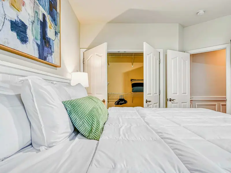 The Junior Primary Suite offers main-level privacy with a cloud-comfortable bed, soft natural light, private ensuite bath, blackout drapery, and spacious storage—perfect for guests who value quiet, comfort, and an elevated suite experience.