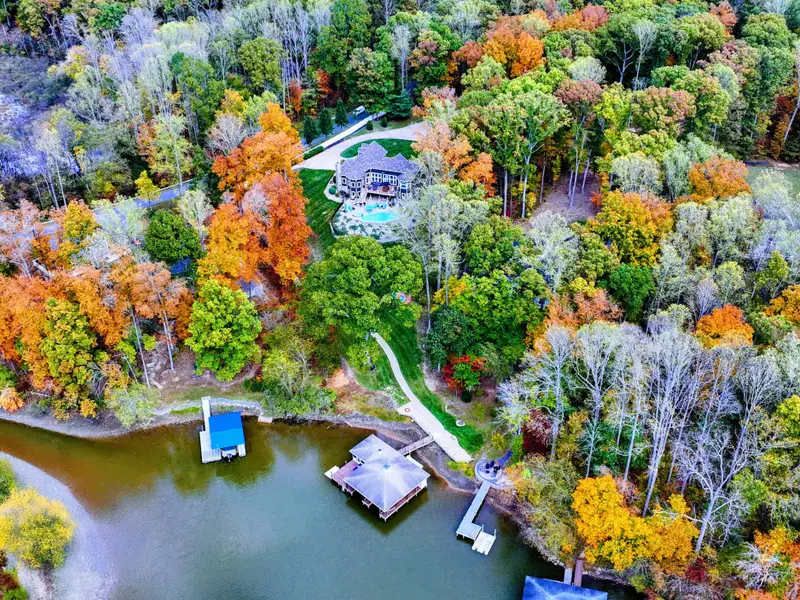 Private lakefront home with heated pool, hot tub, furnished deck + direct dock access.