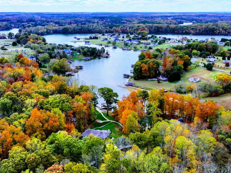 Private lakefront home with heated pool, hot tub, furnished deck + direct dock access.