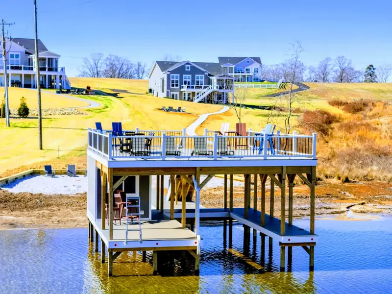 Your Own Lake Club – A two-story boathouse made for sun above, shade below, and easy time together.