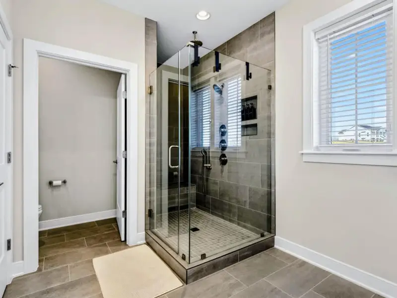 A Spa-Style Reset – Step into the glass shower and let the day rinse away, unhurried.