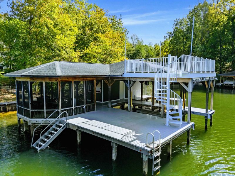 Boathouse - Side view reveals the screened porch and spiral staircase connecting both levels.