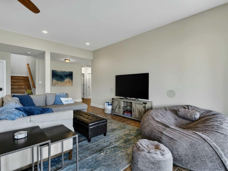 Lower Level Media Area - Plush sectional and oversized bean bag in front of a large TV for movie nights.