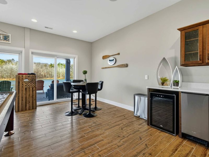 Wet Bar - Pub table, wine cooler, and mini fridge keep refreshments close at hand on the lower level.