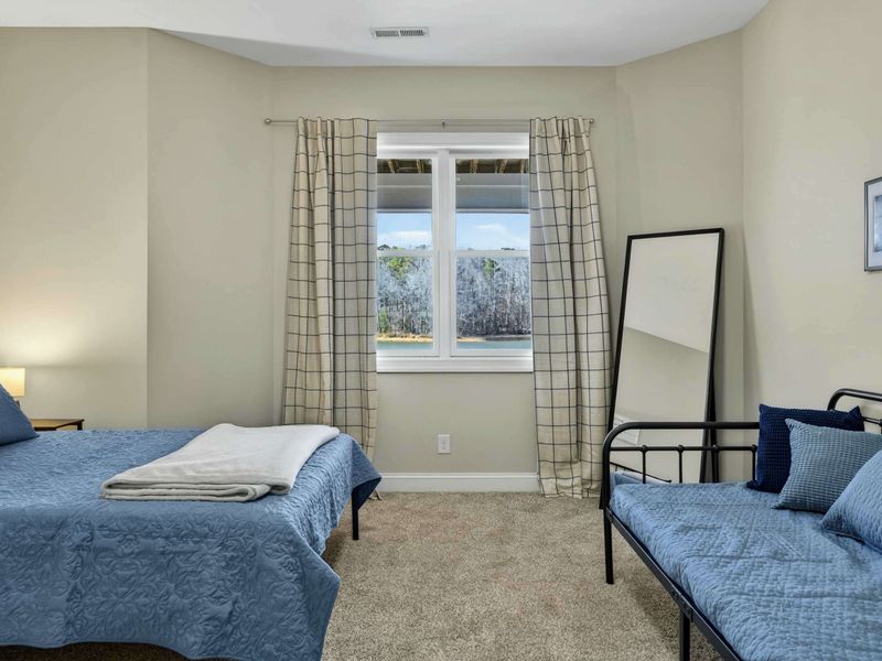 Bedroom 3 - Alternate angle showing both beds and the window with views of the surrounding trees.