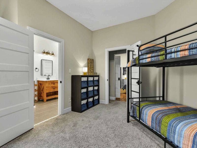 Bunk Room - Reverse angle showing the bunks, bathroom entry, and storage cubbies for little guests.