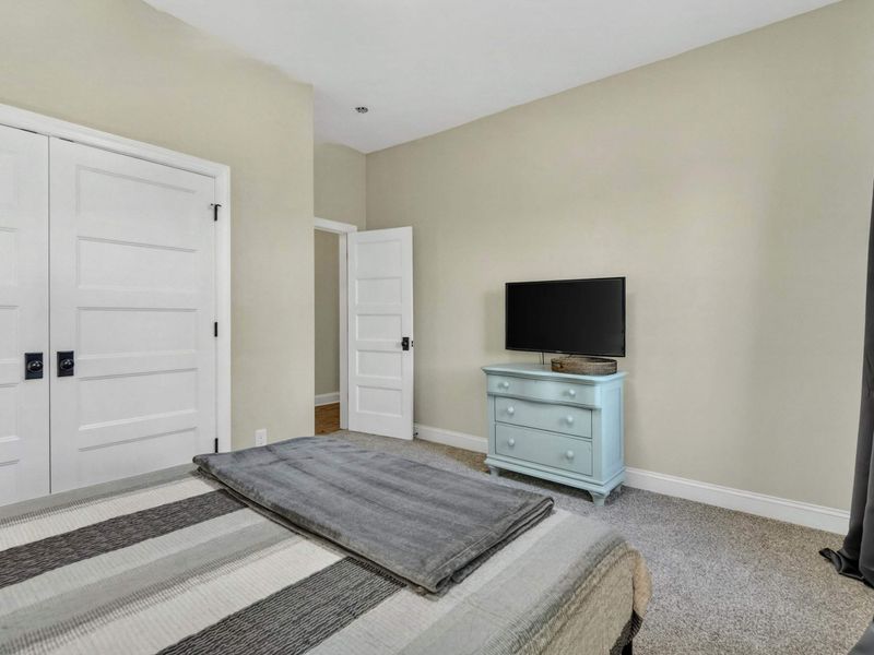 Bedroom 4 - TV on a coastal blue dresser with generous closet space for guests.