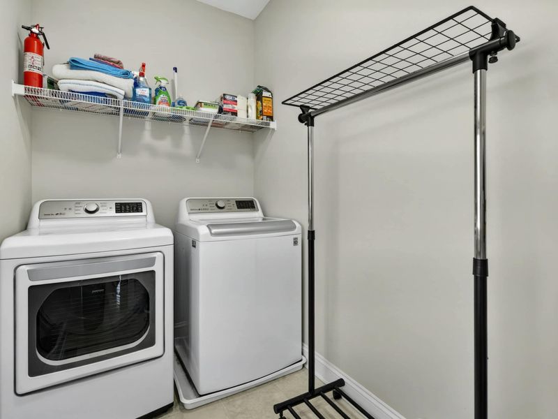 Laundry Room - Full-size washer and dryer with shelving and a drying rack for guest convenience.