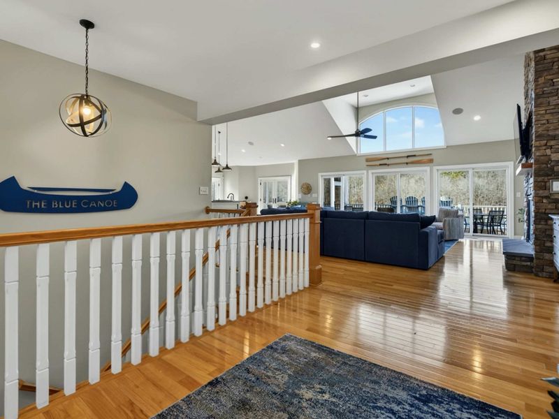 Entry - The Blue Canoe sign greets guests at the top of the stairs, opening to the vaulted great room.