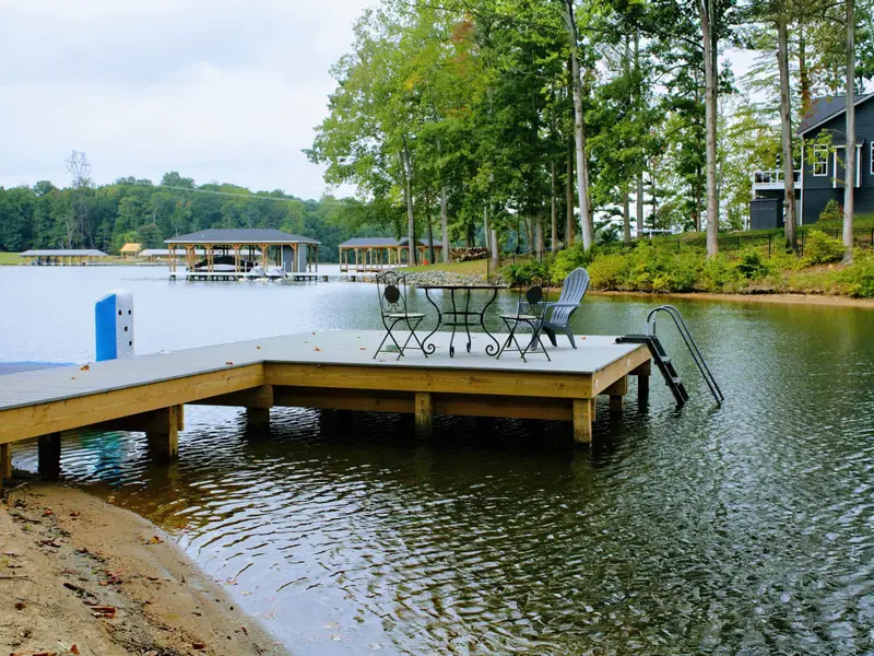 Dock - Bistro table and chairs on the dock invite you to dine lakeside, with a swim ladder for easy water access.