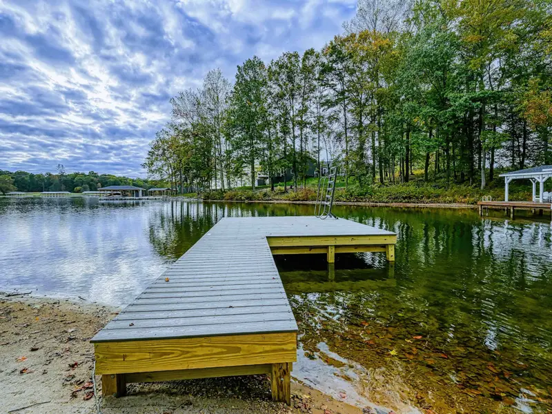 Dock - The private dock extends into the lake with colorful fall foliage lining the shoreline.