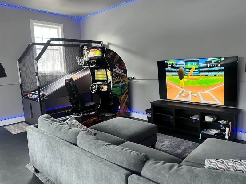 Game Room - Racing arcade, big-screen TV for gaming, and classic arcade cabinet offer endless entertainment.
