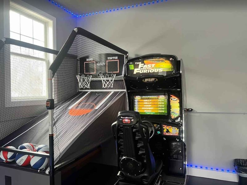Arcade Games - Basketball shootout and racing simulator bring the fun with blue LED accents.