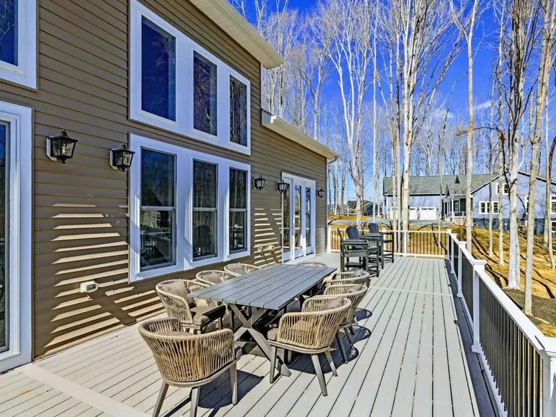Deck Dining - A full outdoor dining table and wicker seating on the main deck, steps from the kitchen.