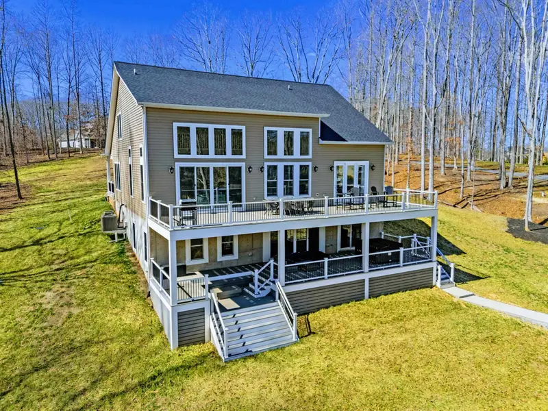 Rear Elevation - Multiple deck levels and a walkout lower level face the waterfront.