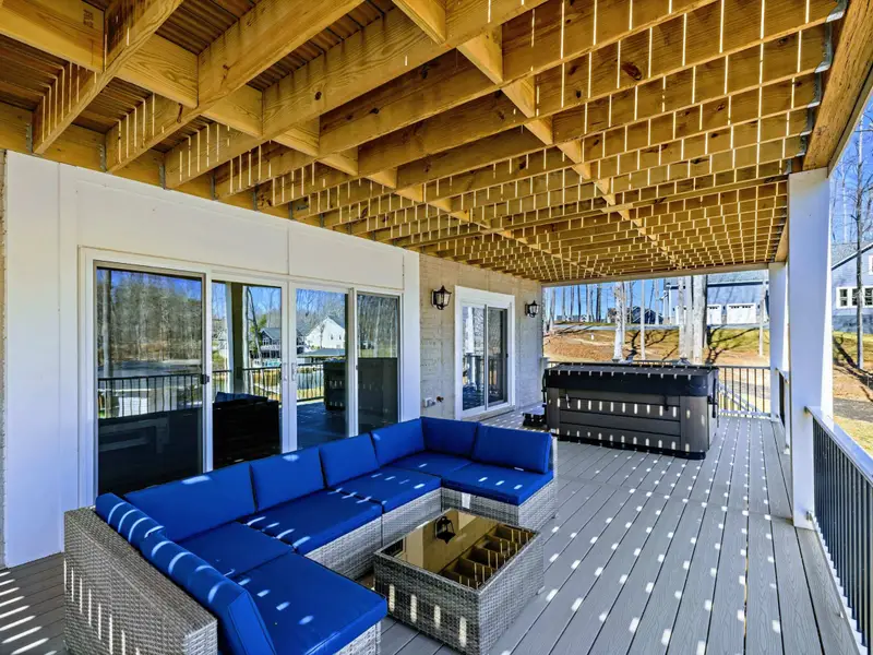 Patio Retreat - Settle into the covered patio with a fire table, sectional, and lake views on every side.