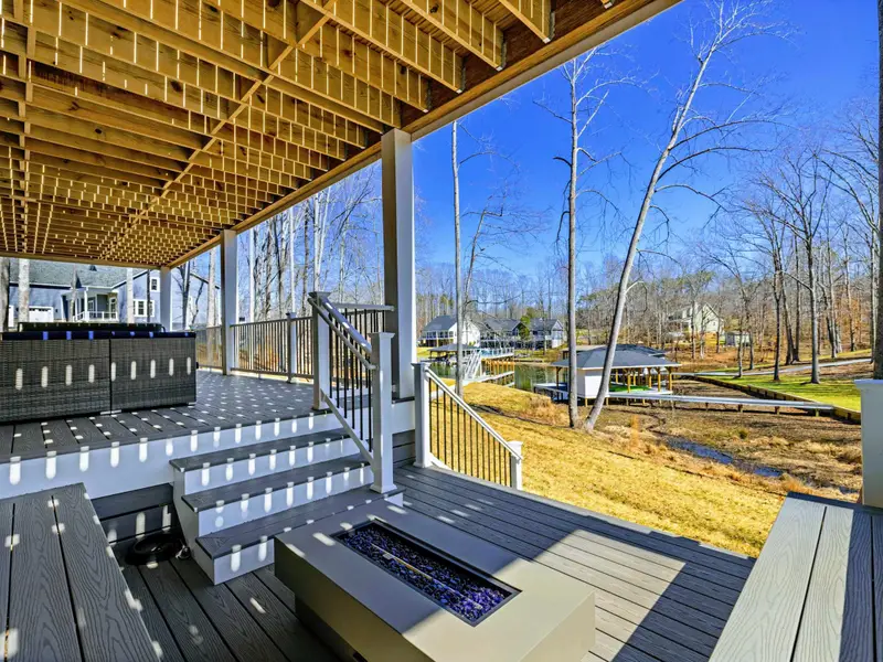 Covered Patio - The covered patio overlooks the fire pit area and the open yard leading down to the water.