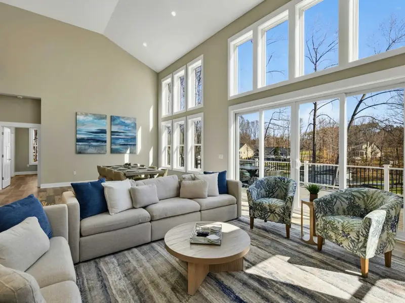 Great Room Views - Floor-to-ceiling windows and vaulted ceilings fill the main living space with natural light.