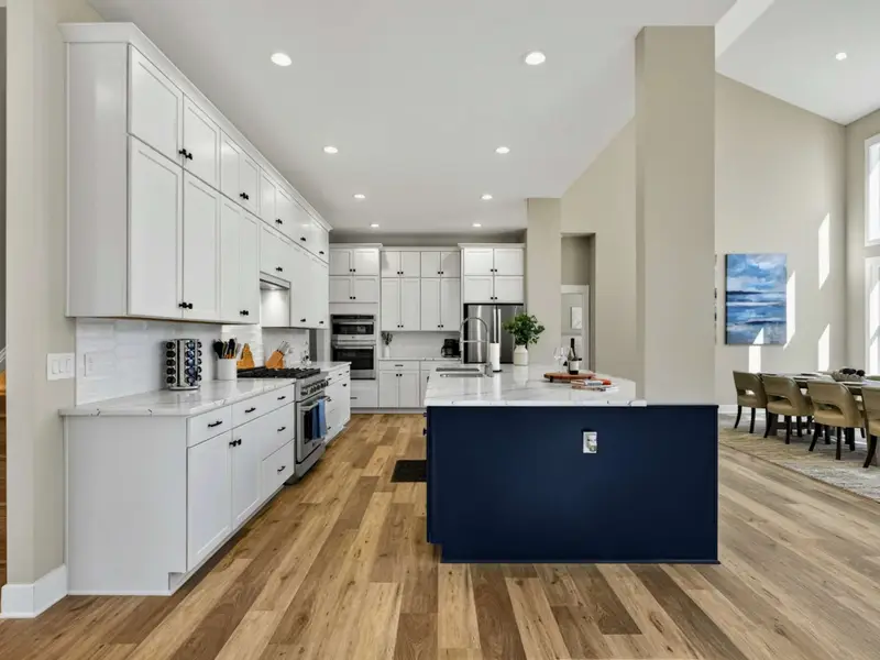 Full Kitchen - White cabinetry, quartz counters, and a navy island give this kitchen both style and substance.
