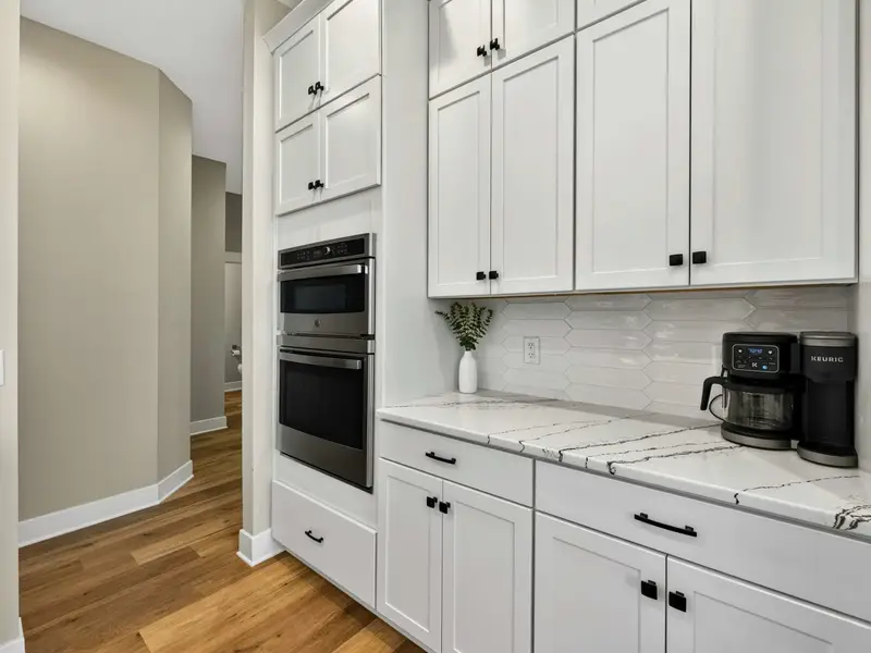 Appliance Wall - A second wall oven, convection microwave, and coffee station with plenty of counter space for morning routines.
