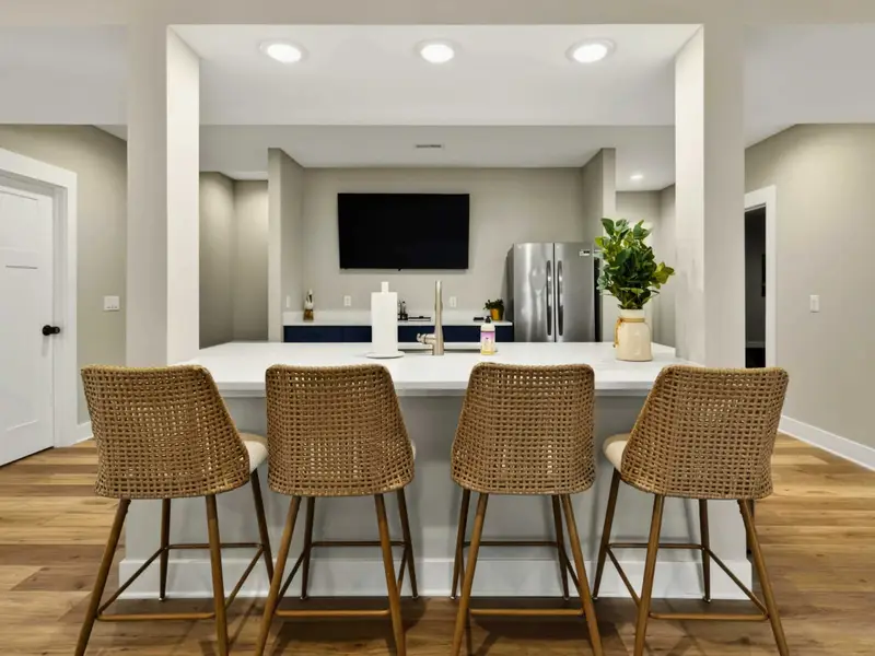 Lower Level Bar Detail - Navy cabinetry and a spacious counter mirror the main kitchen's style downstairs.