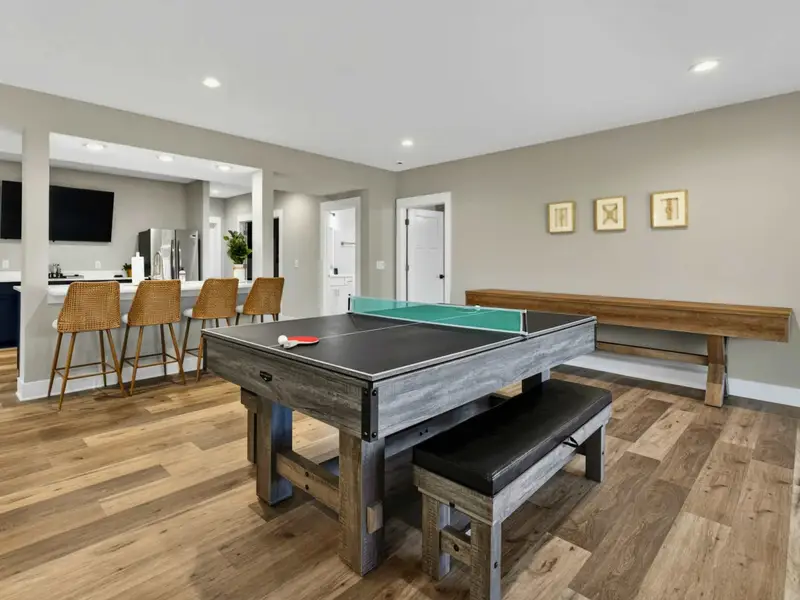 Game Room Angle - Pool table center stage with bar seating and the shuffleboard just behind.