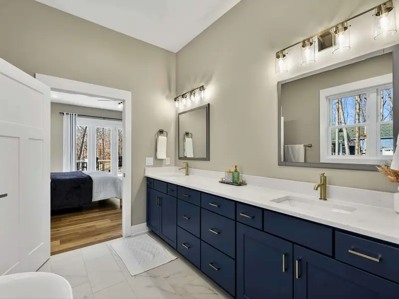 Mirror and Light - Soft lighting and a well-placed mirror set the tone in the primary bath.