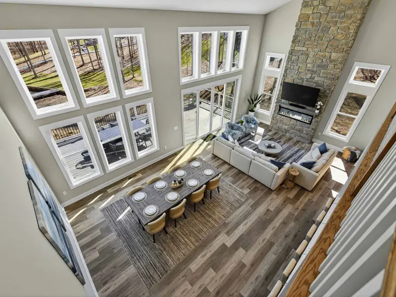 Loft View Down - From the open loft, the full scale of the great room and its lake-facing windows unfolds.