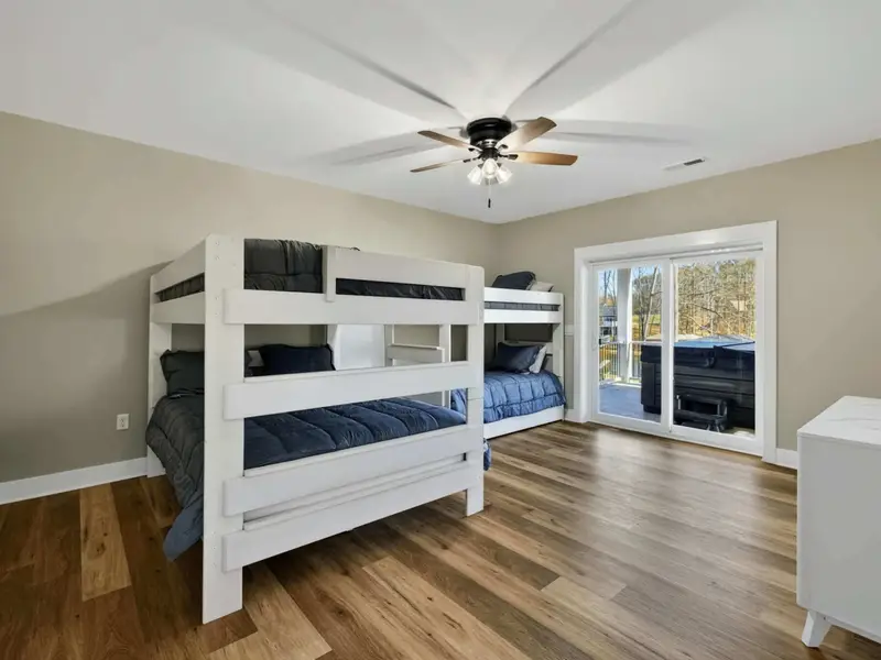 Bunk Room - A spacious bunk room with French doors to the deck, perfect for kids or extra guests.