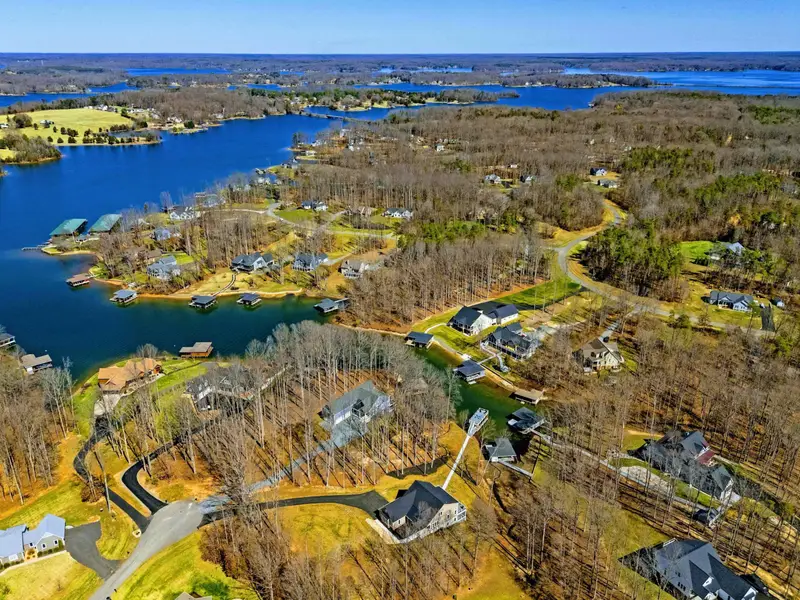 Approach View - The first impression from the road: a polished lake house ready for your arrival.