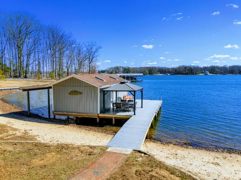 Dock and Beach - The full boathouse, dock, and sandy beach come together in one lakeside scene, with a walkway connecting everything to the yard above.