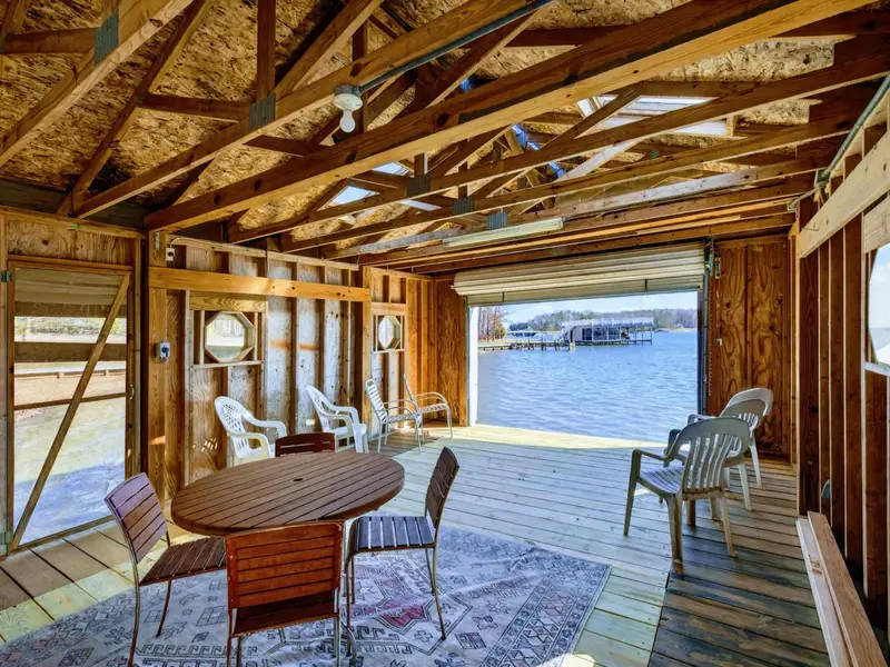 Boathouse Lounge - The converted boathouse opens directly onto the lake, with a round table, comfortable seating, and exposed beam ceilings for a one-of-a-kind hangout.