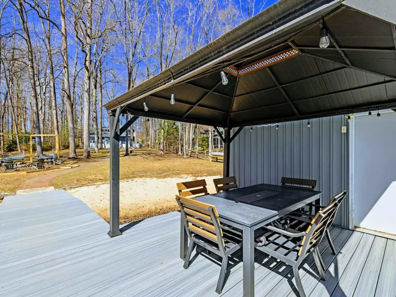 Gazebo and Yard - The covered dining gazebo connects to the full dock, with the yard and play areas visible in the background.