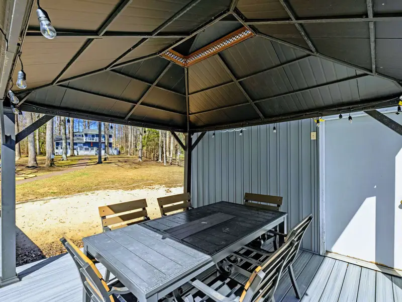 Gazebo View - Looking back from the covered dining area toward the sandy beach and spacious yard beyond.