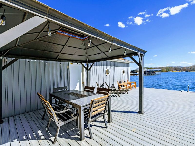 Lakeside Dining - The covered gazebo on the dock seats 8+ guests for meals right on the water, with string lights overhead for evening ambiance.