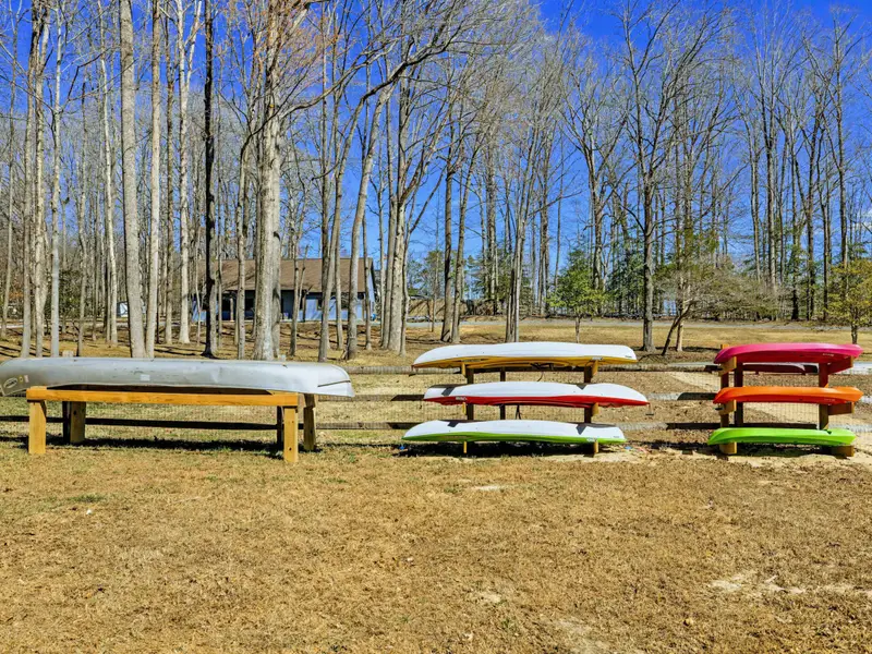 Kayak Fleet - Six colorful kayaks and a canoe sit ready on storage racks, so the whole group can get out on the water together.