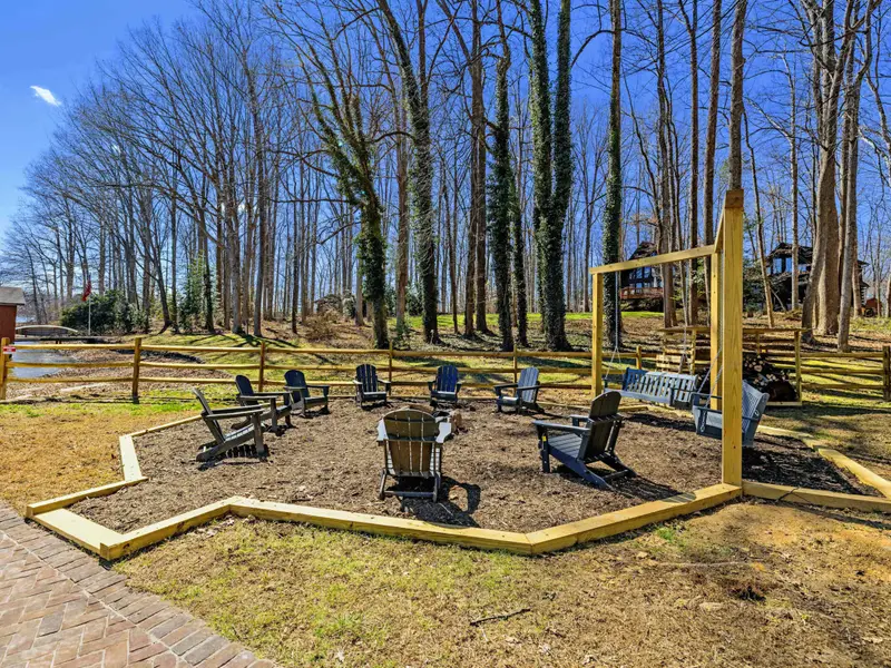 Fire Pit Circle - Seating for 14 around the fire pit, plus two bench swings on a yellow A-frame, make this the gathering spot after sunset.