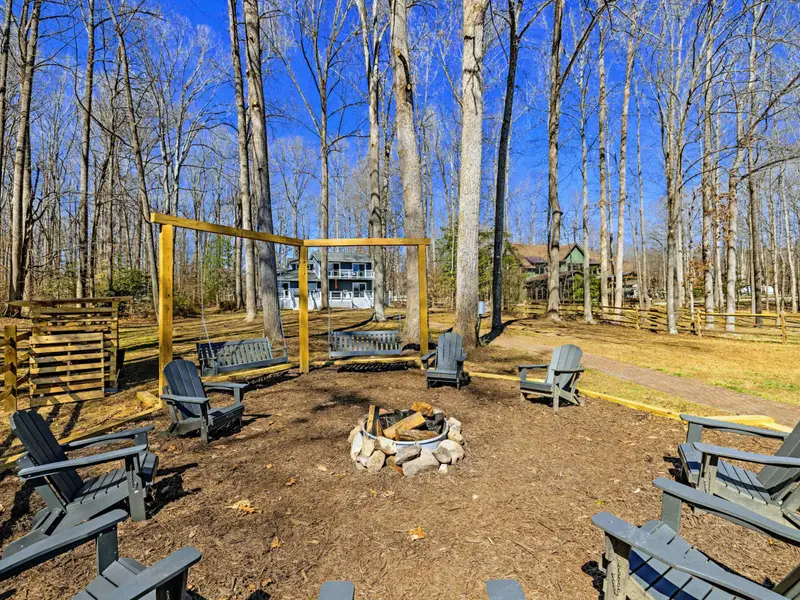 Bench Swings - Two Polywood bench swings on a sturdy A-frame sit right beside the fire pit, perfect for swaying and stargazing.