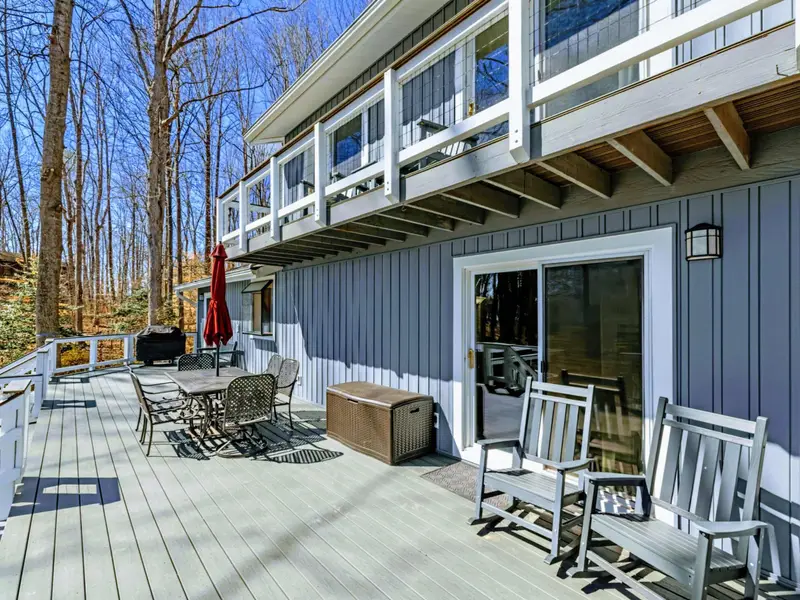 Lower Deck - The spacious lower deck brings together dining, rocking chairs, and grill access, all steps from the yard and lake path.