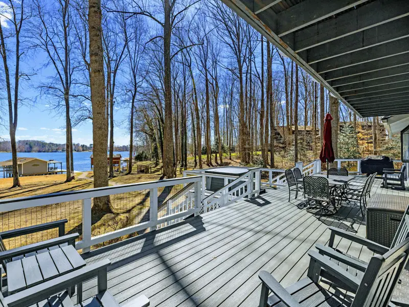 Deck Overlook - Rocking chairs line the main deck railing with views down through the trees to the lake, making this the go-to spot for morning coffee.