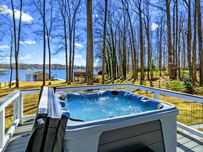 Hot Tub - Bubbling and ready, the hot tub looks out through the trees toward the water for a soak under the stars.