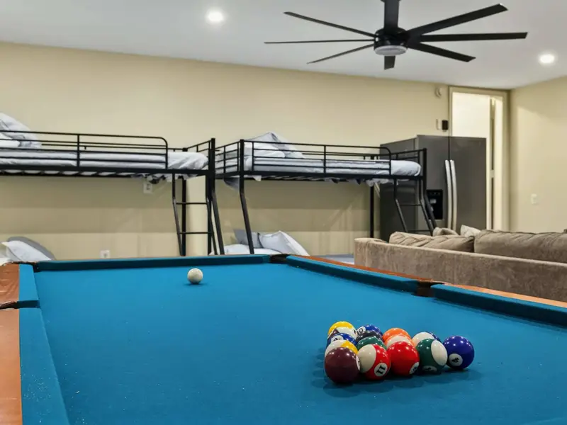 Pool Table and Bunks - The pool table sits center stage with twin-over-full bunk beds and a full-size fridge just behind for easy snack access.