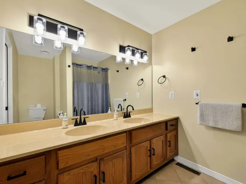Ensuite Bath - Another angle of the double vanity shows the generous counter space and clean, well-lit layout of the primary ensuite.