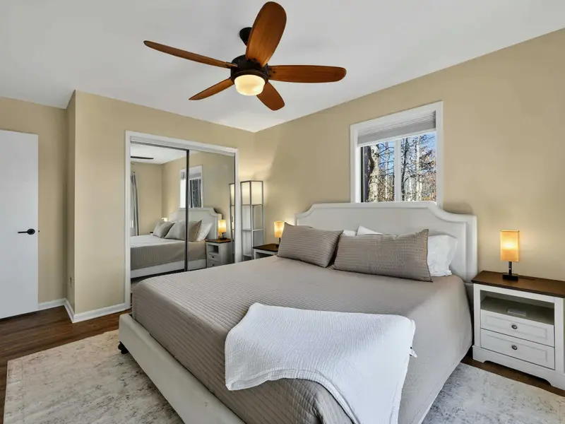Upper Bedroom - Mirrored closet doors and a ceiling fan keep this king room bright and comfortable.