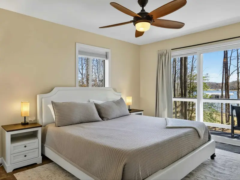 Upper Bedroom - Wake up to lake views framed by the sliding glass door, with the balcony just a step away.