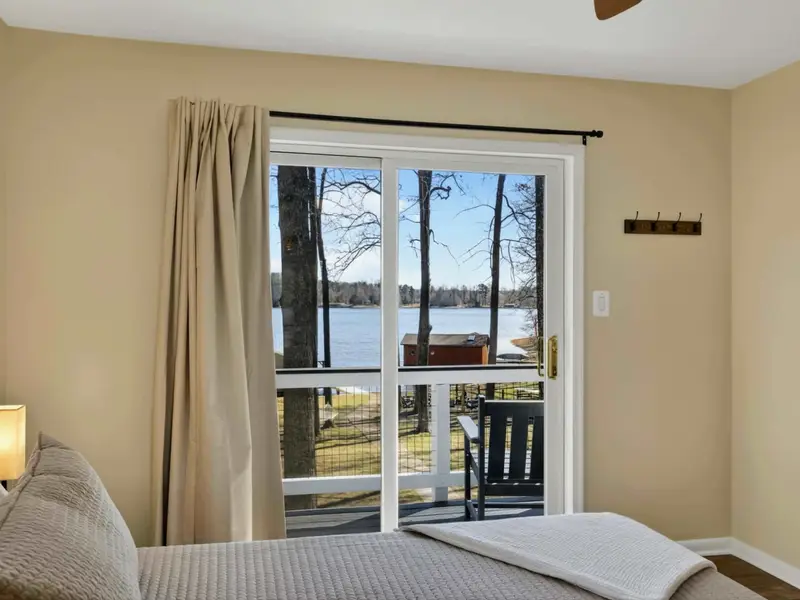 Balcony View - A bistro table on the private balcony looks out through the trees to the lake, perfect for morning coffee.