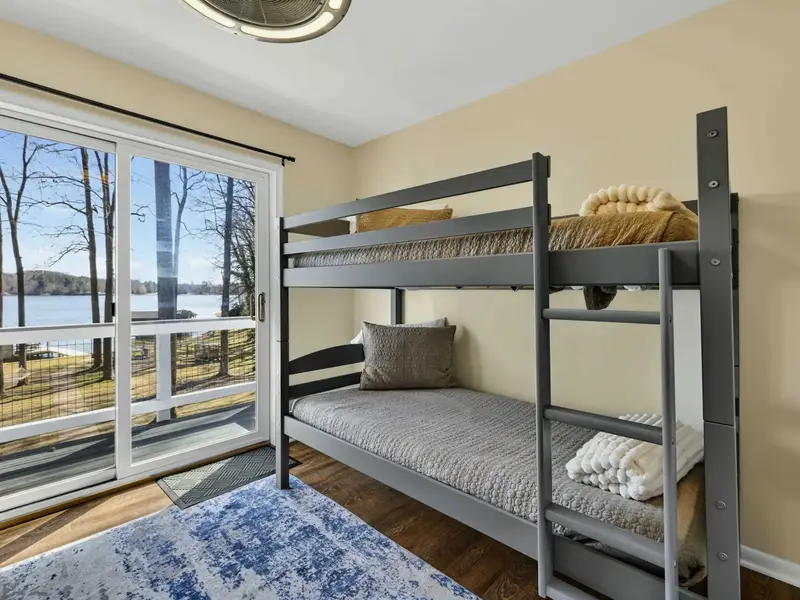 Bunk Room - A closer look at the bunks, with the lake shimmering through the sliding glass door.